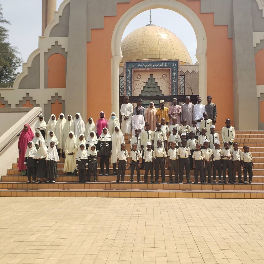 A large group of pupils and staff during a school community outing